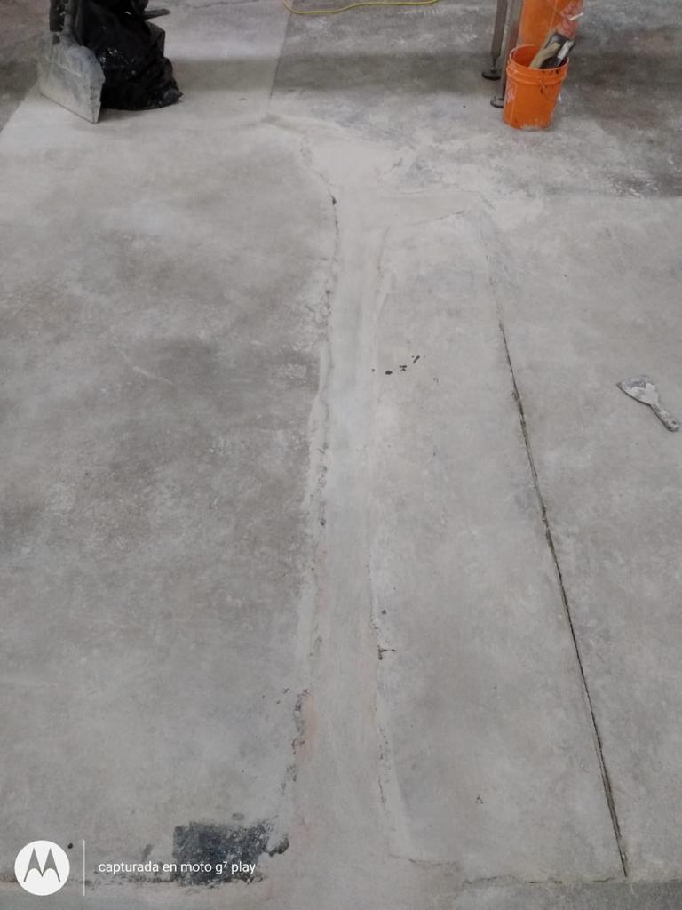 Concrete crack repair in progress, routed and filled with high-strength material